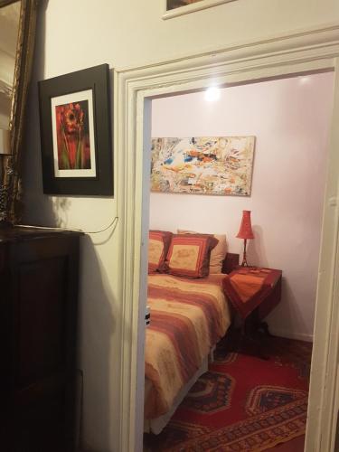 a bedroom with a bed and a painting on the wall at Family Apartment Old Town near Beach AC in Nice