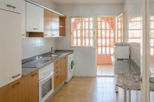 a kitchen with a sink and a dishwasher at Apartamentos Zambra III in La Manga del Mar Menor