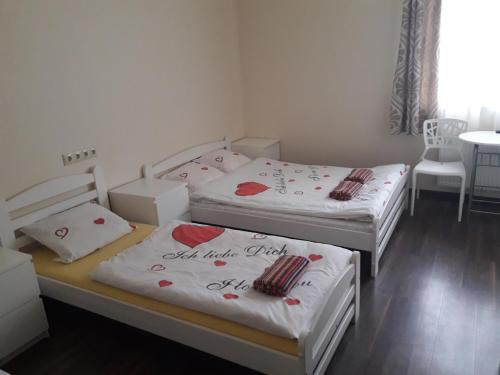 two twin beds in a room with boxes at Happy Hotel in Rīga