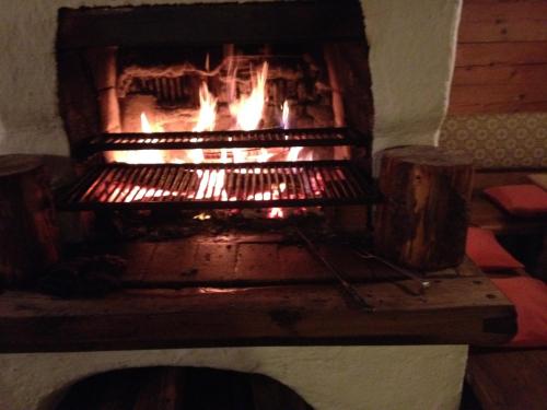 a fireplace in a room with fire in it at Chalet Valley in Valley