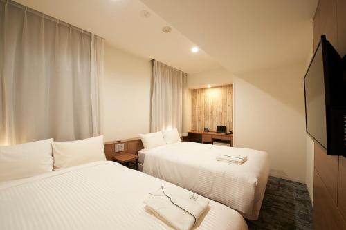 מיטה או מיטות בחדר ב-Sotetsu Fresa Inn Ueno-Okachimachi