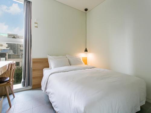 Ένα ή περισσότερα κρεβάτια σε δωμάτιο στο H Avenue Hotel Dongdaemun Sungshin