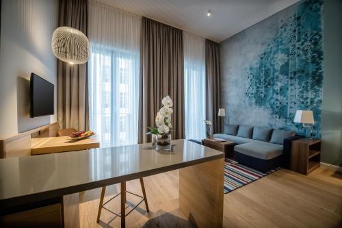 a living room with a table and a couch at The Wellem, in The Unbound Collection by Hyatt in Düsseldorf