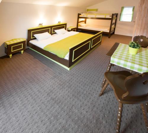 a bedroom with a bed and a table and a chair at Ridehouse in Schladming