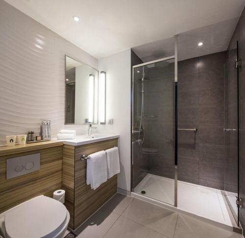 La salle de bains est pourvue d'une douche, de toilettes et d'un lavabo. dans l'établissement Campanile Le Mans Centre - Gare, au Mans