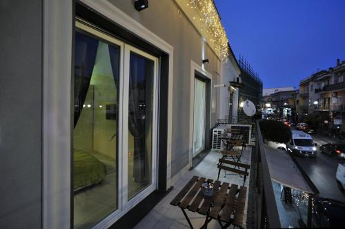 a balcony with a bench and a view of a street at Room Positano in SantʼAntonio Abate
