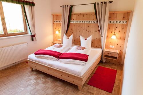 a bedroom with a canopy bed with two pillows at Biohof Seidl in Bad Kleinkirchheim