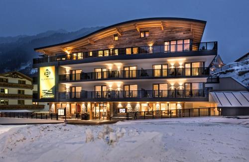 a large building in the snow at night at Hotel Eldorado in Ischgl