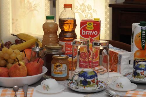 a table topped with jars of food and fruit at L'incrocio - Bed&Breakfast in Imola