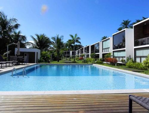 a large swimming pool in front of a building at Barra Grande Exclusive Residence in Barra Grande