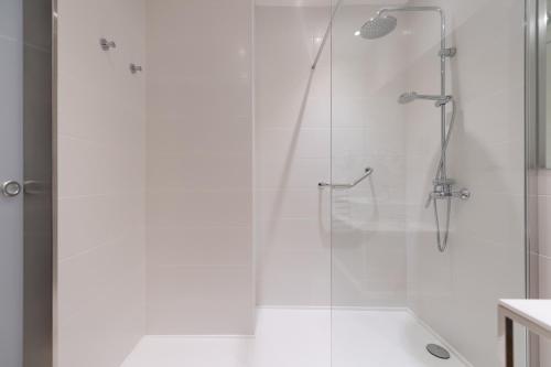 a bathroom with a shower with a glass door at HC Luxe in Vecindario
