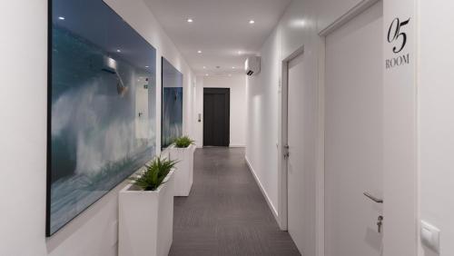 a hallway of an office with white walls and plants at HC Luxe in Vecindario