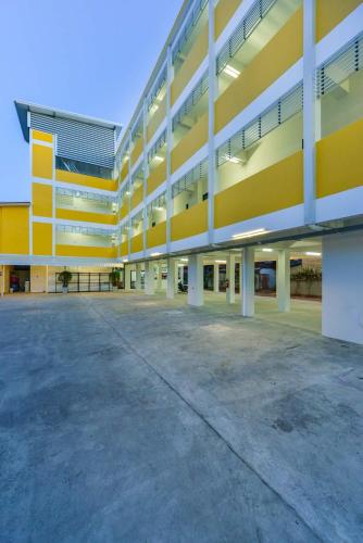 an empty parking lot in front of a building at Jarat Mansion in Surin