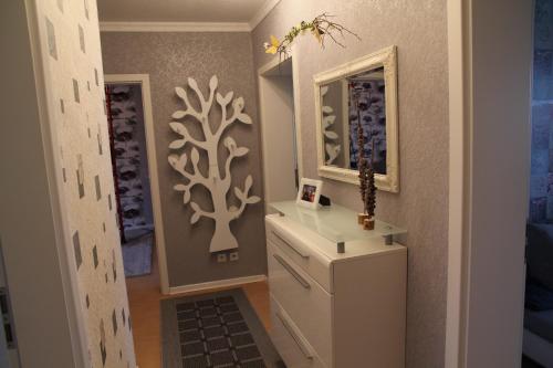 a bathroom with a white dresser and a mirror at BS Business Travelling Hannover Messe in Hannover