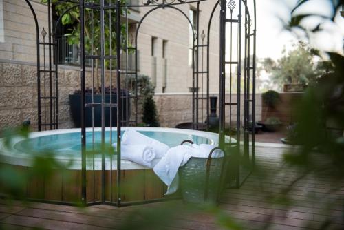 a jacuzzi tub with towels in a building at Leonardo Boutique Jerusalem in Jerusalem