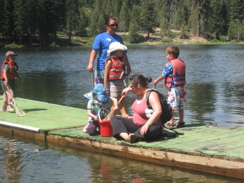 a group of people on a raft in the water at Montecito Sequoia Lodge in Sequoia National Park