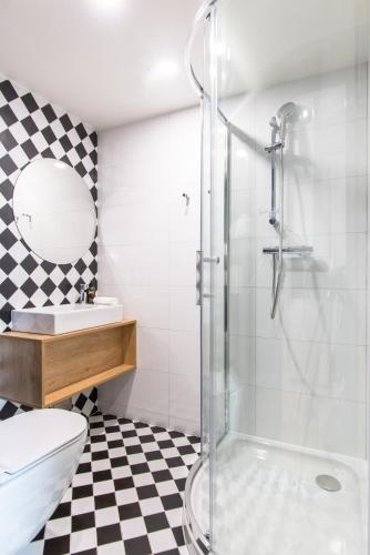 a bathroom with a shower and a toilet and a sink at MeetMe23 in Prague