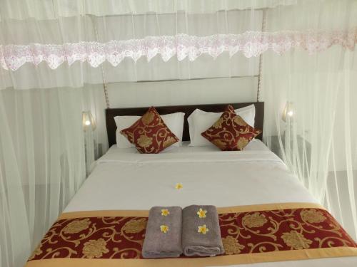 Krevet ili kreveti u jedinici u objektu Lombok Holiday Hotel
