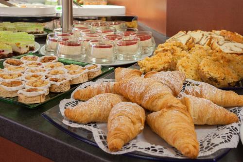 a table topped with lots of different types of pastries at Best Western Hotel Augusta in Augsburg