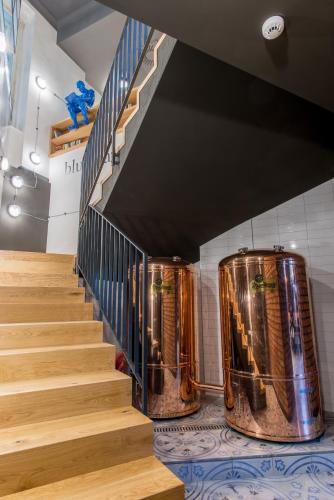 a set of stairs in a building with copper drums at MeetMe23 in Prague