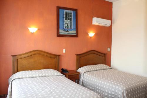 En eller flere senger på et rom på Hotel Posada Doña Lala