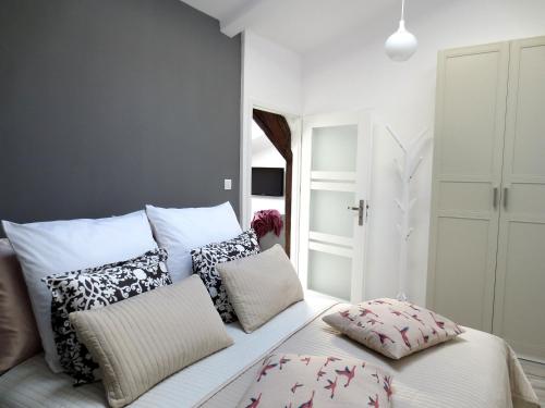 a bedroom with a white bed with pillows on it at Apartament krakowski GIMO na Kazimierzu in Krakow
