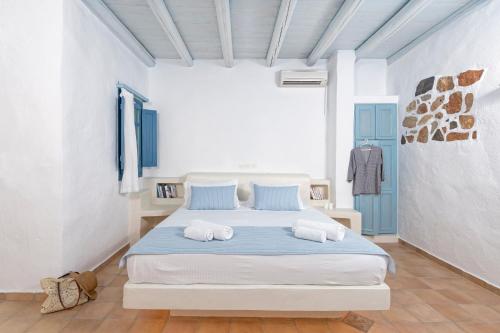 a bedroom with a bed with two pillows on it at Kalderimi Residencies in Astypalaia