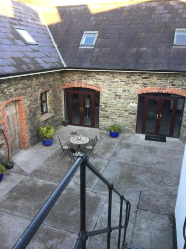 a patio with a table in front of a building at Redington House SelfCatering accommodation in Cobh