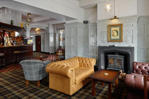 a living room with a couch and a fireplace at The Royal Oak in Settle