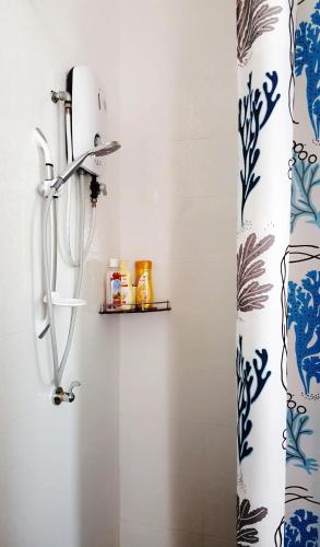 a bathroom with a shower curtain and a shelf at Mahkota Cheras Sweet Condo 1-14 pax near MRT to KL in Kuala Lumpur