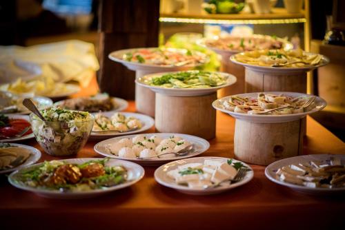a table with many plates of food on it at Hotel Carpatia Bieszczadzki Gościniec in Wetlina