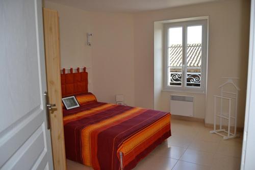 une chambre avec un lit avec un ordinateur portable dessus dans l'établissement Gite Du Chai, à Chenac Saint Seurin D'uzet