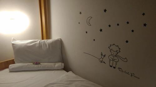 a bedroom with a bed with a sticker on the wall at Ciszterci Szállás Pécs in Pécs