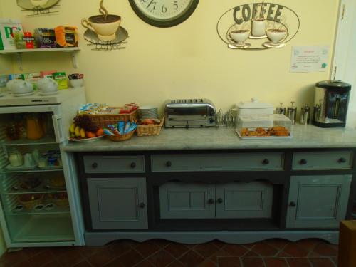 a kitchen with a counter with food on it at Trumbles Gatwick B&B in Charlwood