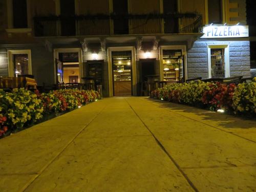 a walkway in front of a building at night at Locanda La Sosta in Cavaion Veronese