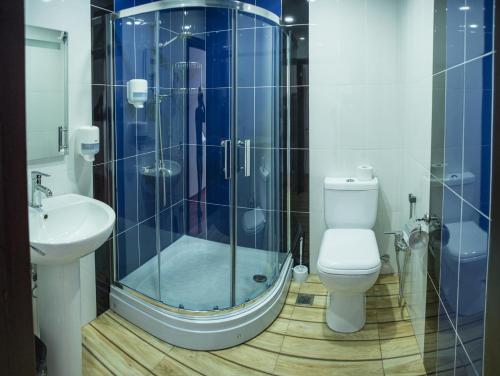 a bathroom with a shower and a toilet and a sink at SAHIL Hostel & Hotel in Baku