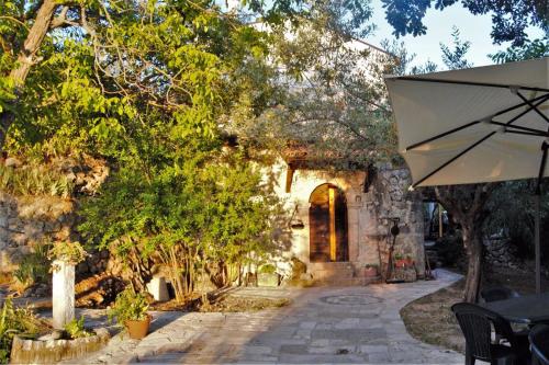 an entrance to a stone building with an umbrella at Fattoria La Tana della Volpe in Pacentro