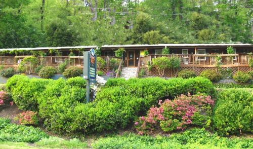 a house with a lot of bushes and flowers at The Chimney Rock Inn & Cottages in Chimney Rock