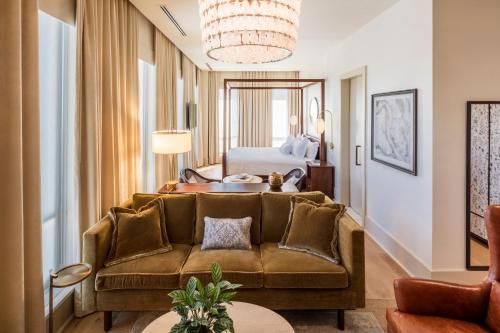 a living room with a couch and a bed at The Dewberry Charleston in Charleston