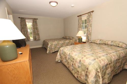 a hotel room with two beds and a television at Kentucky Dam Village State Resort Park in Gilbertsville