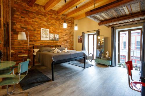 a bedroom with a bed and a brick wall at Hotel & Depandance Kopacka in Lanškroun