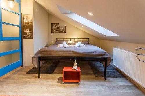 a bedroom with a large bed in a attic at Hotel & Depandance Kopacka in Lanškroun