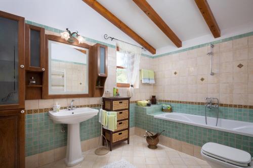 a bathroom with a sink and a tub and a toilet at Villa Primela**** in Labin
