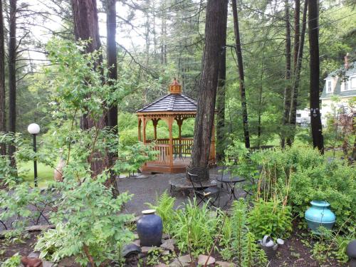 a gazebo in the middle of a garden at Brookview Manor Inn in Canadensis