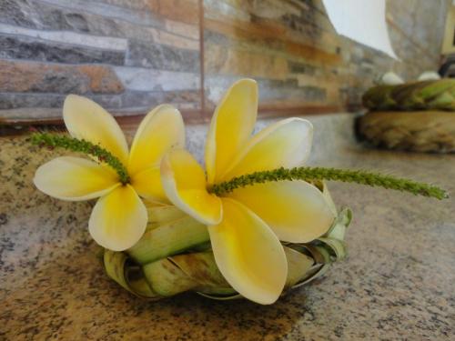a pineapple with yellow flowers on top of it at Cabañas Akiko in Hanga Roa