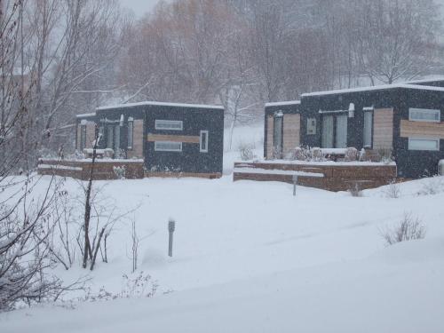 a couple of buildings in the snow at Camping-Hotel de Plein Air Les 2 Bois in Baratier