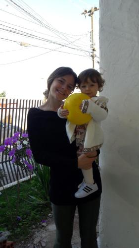 a woman and a child standing next to a building at Pousada Catarina in Maringá