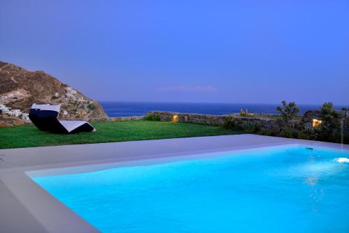 a swimming pool with a view of the ocean at Villa Castalia by Thalassa Residence Mykonos in Elia Beach