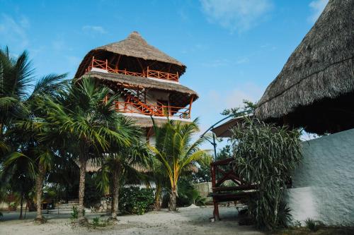 a resort on the beach with palm trees at Ensueño Holbox & Beach Club in Holbox Island
