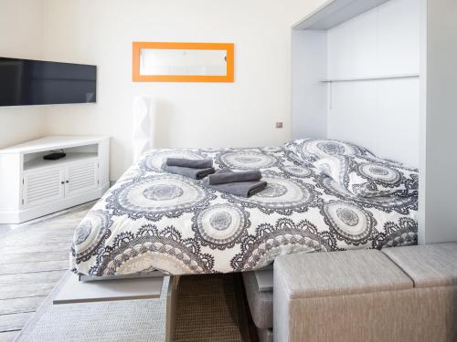 a bedroom with a large bed and a tv at Studio triangle d'Or in Bordeaux